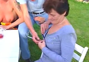 Lingerie-wearing beauty sucks cock outdoors