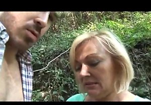 Fair-haired mature strokes cock in the woods